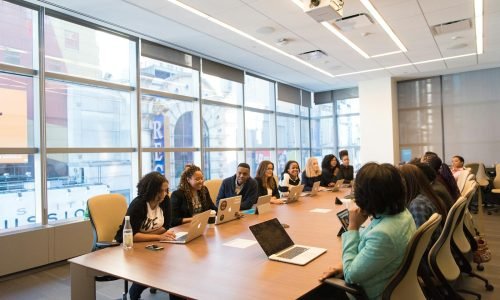 A diverse team of business professionals collaborating in a modern meeting room.